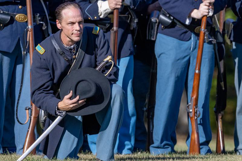 Tim Marcus, company captain of the 100th Illinois Division, kneels down as he listens to a speech from Abraham Lincoln during the Shadows Of The Blue and Gray Civil War reenactment at City County Park on October 10, 2025 in Princeton.
