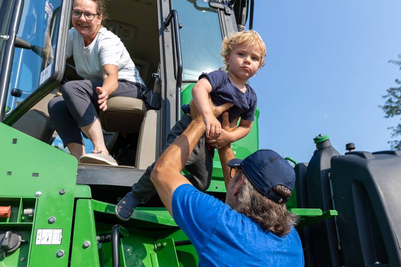 Oliver gets picked up out of tractor by Jeff on Saturday, August 9, 2025 at the annual Wenona Days on Chestnut Street in Wenona.