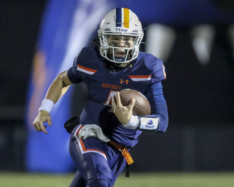 Oswego's Drew Kleinhans (4) runs with the ball during Class 8A semifinal football game between Lockport at Oswego. Saturday, Nov 22, 2025 in Oswego.