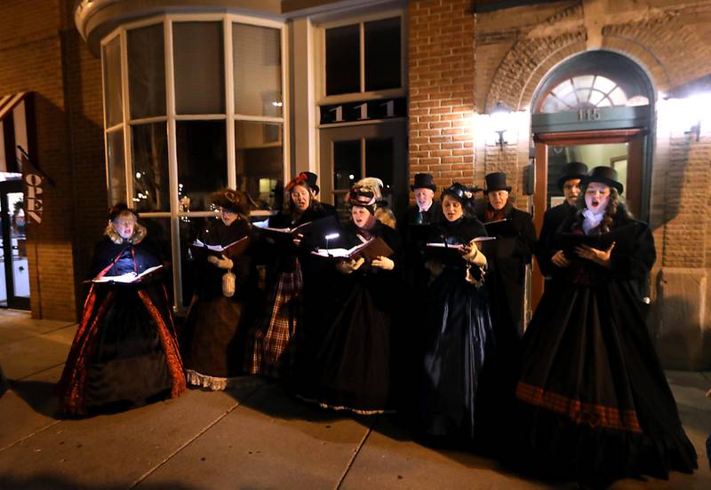 The Dickens Carolers sing during the Lighting of the Square on Friday, Nov. 28, 2025, in Woodstock.The annual holiday season event featured brass music, caroling, free doughnuts and cider, food trucks, festive selfie stations and shopping.