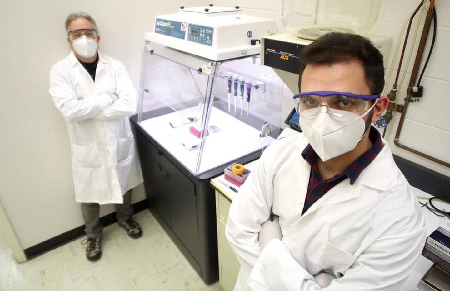 Director of COVID-19 Facilities Dr. Barrie Bode and Research Associate Syed Hyder test processes in the laboratory at Montgomery Hall on the campus of Northern Illinois University in DeKalb on Wednesday, Jan. 27, 2021. The various chemical and physical processes the two are testing will be used to gauge the presence of the COVID-19 virus in wastewater samples.