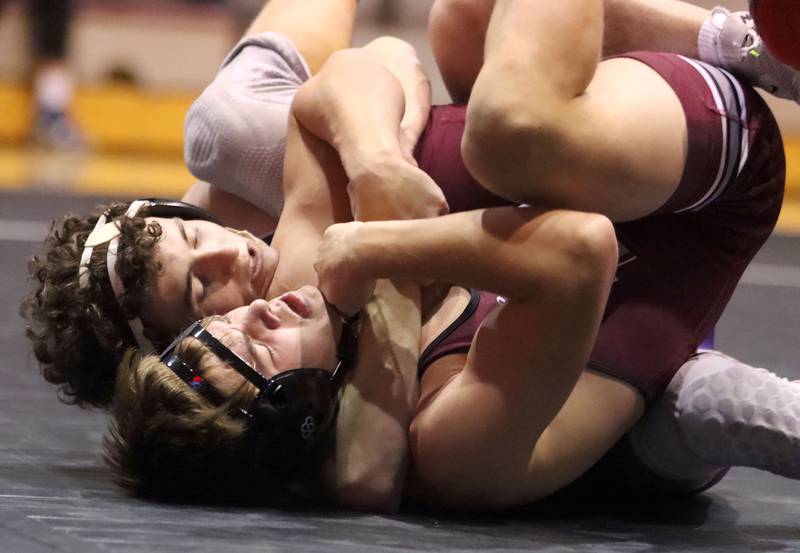 Prairie Ridge’s Caleb Harmke, front, battles Hampshire’s Dawson Smith at 144 pounds in varsity boys wrestling on Thursday, Dec. 4, 2025, at  Prairie Ridge High School in Crystal Lake.