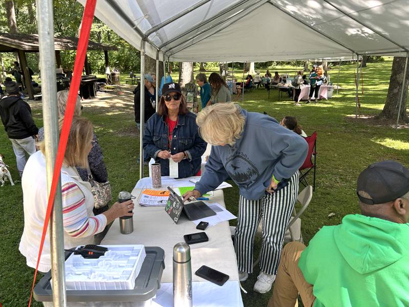 People check in to Fest by the Nest at Lowden State Park on Saturday, Sept. 6, 2025. The event was organized by Together for Taft, a nonprofit, to raise funds and awareness of an effort to reopen the Lorado Taft Field Campus that was shuttered by Northern Illinois University in December 2024.