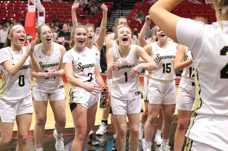 Sycamore players celebrate after receiving the trophy for beating DeKalb in the girls game at the First National Challenge Friday, Jan. 27, 2023, at The Convocation Center on the campus of Northern Illinois University in DeKalb.