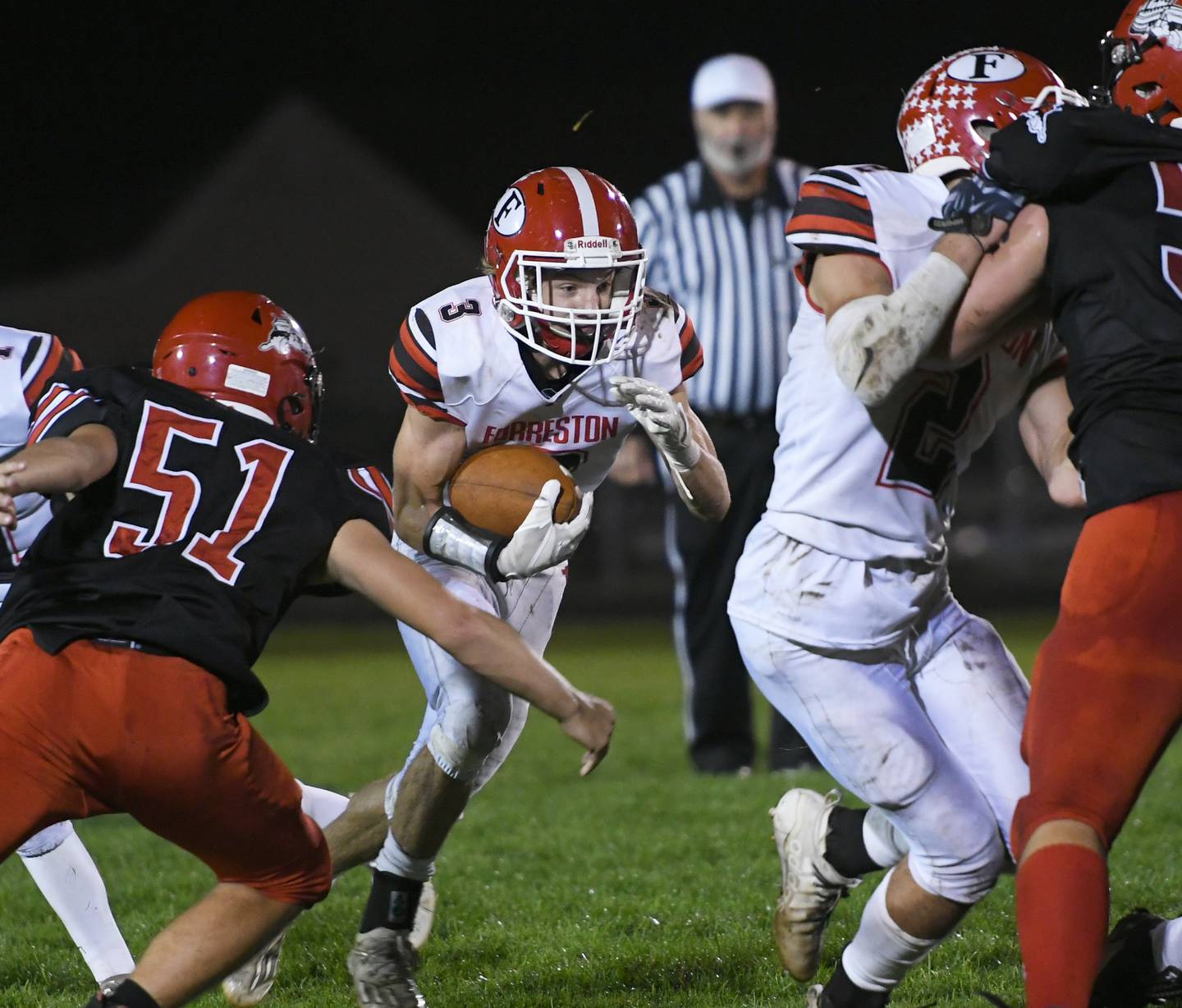 Forreston's Jacob Fiorello protects the ball as he runs against Fulton.