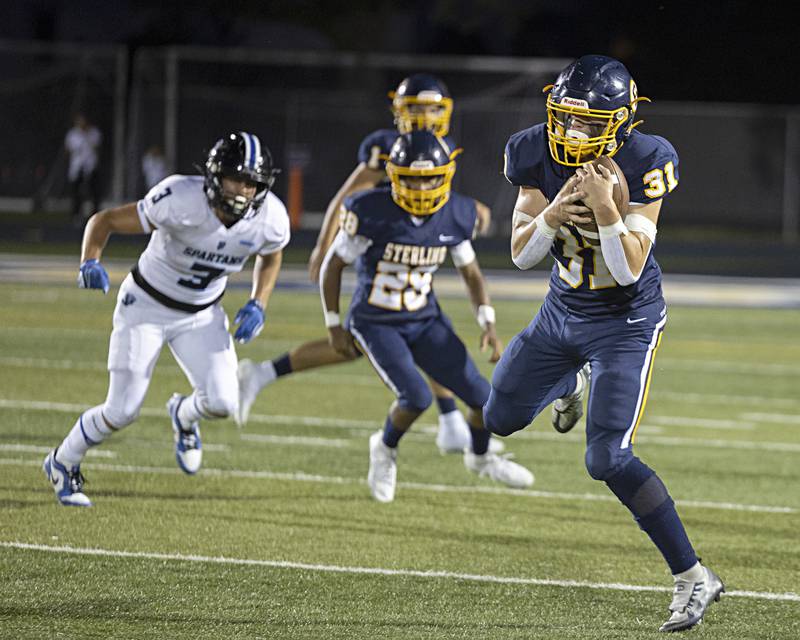 Sterling’s Gage Tate hauls in a pass against St. Francis Friday, Sept. 1, 2023 at Sterling High School.