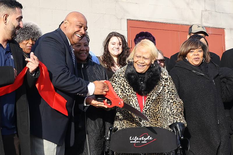 Marcus Mitchell along with his mother Peggy Mitchell ribbon outside the Ozzie & Peggy Mitchell Center, formerly the Peter Claver Center, Joliet Township's new violence prevention program on Wednesday, Jan. 17th, 2024 in Joliet.