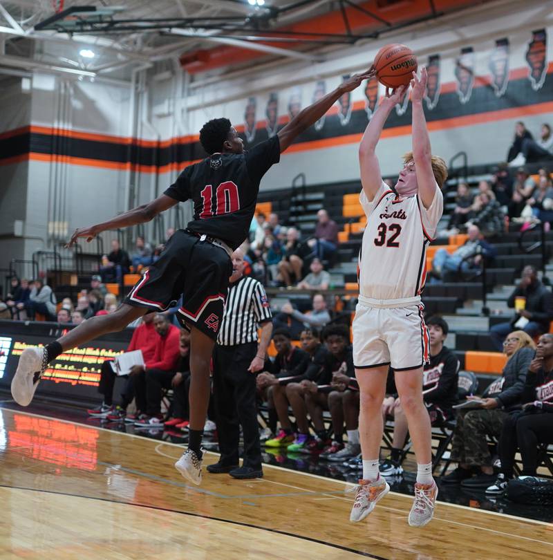 East Aurora's Davion Tidwell (10) defends against a three point attempt by St. Charles East's Bradley Monkemeyer (32) during the 64th annual Ron Johnson Thanksgiving Basketball Tournament at St. Charles East High School on Monday, Nov 20, 2023.