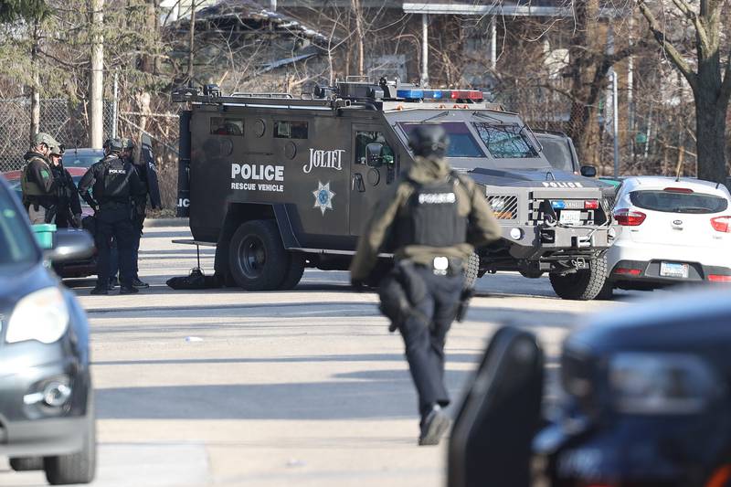 Joliet police stage outside a home along the 500 block of Irving Street during a standoff on Thursday, Jan. 9, 2025 in Joliet.