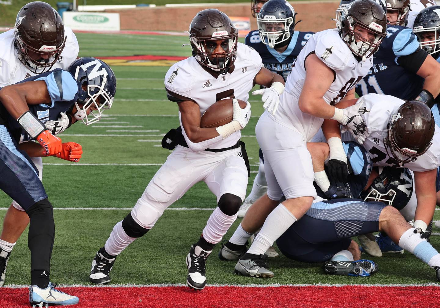 Joliet Catholic's HJ Grigsby finds a hole in the Nazareth defense and runs for a touchdown Saturday, Nov. 25, 2023, during their IHSA Class 5A state championship game in Hancock Stadium at Illinois State University in Normal.