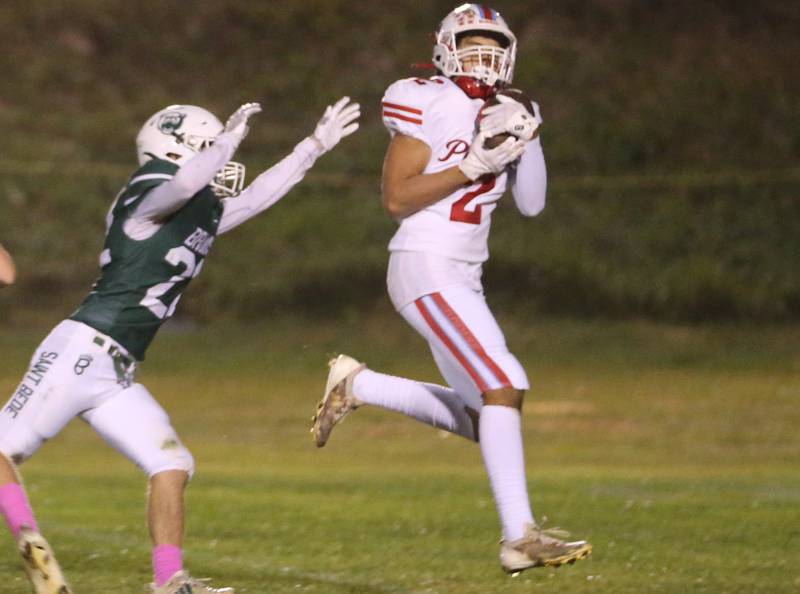 Ottawa's Andrew Vercolio makes a catch to run in for a touchdown over St. Bede's Ryan Nawa on Friday, Oct. 25, 2024 at St. Bede Academy.