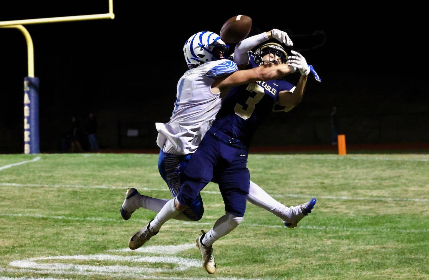 Princeton's Casey Etheridge breaks up a pass intended for Mercer County's Holden Demuth in Friday's Three Rivers Conference crossover at Aledo. The Tigers won 41-22.