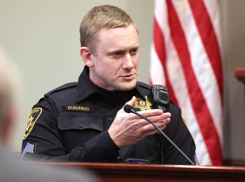 DeKalb County Sheriff's Detective Josh Duehning points out Jonathan D. Hurst in the courtroom Monday, Jan. 27, 2025, during day three of the Hurst trial at the DeKalb County Courthouse in Sycamore. Hurst is charged in the 2016 slayings of Sycamore elderly mother and son Patricia and Robert Wilson.