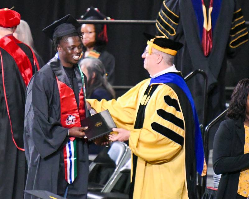 A Northern Illinois University graduate is all smiles after receiving his diploma on Saturday, May 10, 2025, during the Class of 2025 Commencement ceremony held at the Convocation Center in DeKalb.