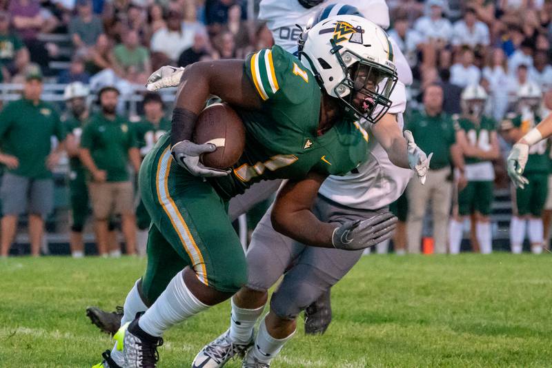 Waubonsie Valley's Chrisjan Simmons (1) carries the ball against Oswego East during a football game at Waubonsie Valley High School in Aurora on Friday, Aug. 25, 2023.