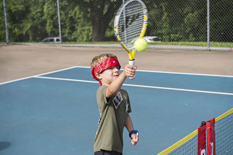 Jed Nagy plays the ball while competing in the tiny tots event at the Emma Hubbs Tennis Classic Monday, July 25, 2022.