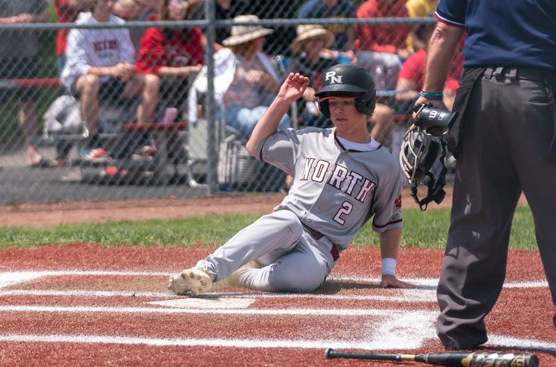 Plainfield North's John St. Clair (2) slides into home for a score against Yorkville during the Class 4A Yorkville Regional baseball final at Yorkville High School on Saturday, May 28, 2022.