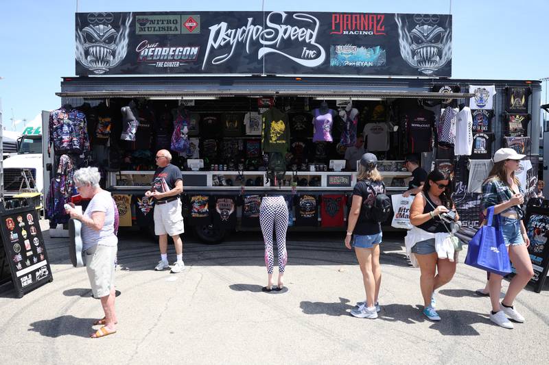 Fans check out one of the many merchandise stands at the NHRA’s Gerber Collision and Glass Route 66 Nationals at Route 66 Raceway on Sunday, May 19, 2024 in Joliet.