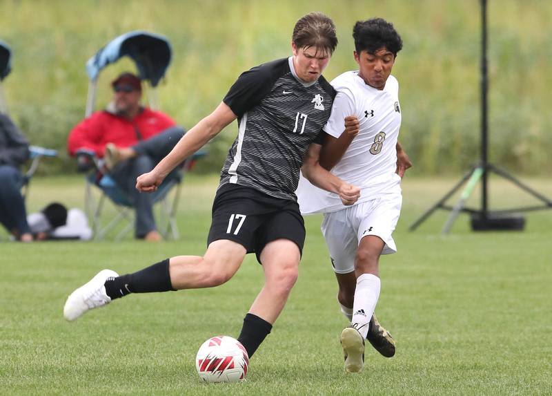 Kaneland's Riley Adams kicks the ball by Sycamore's Ronaldo Ocelotl during their game Wednesday, Sept. 6, 2023, at Kaneland High School in Maple Park.