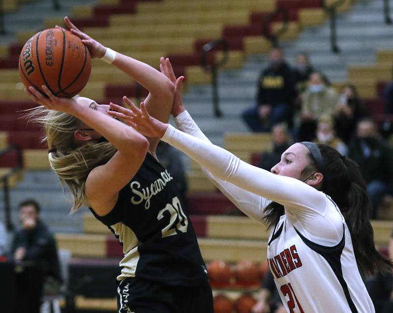 Sycamore’s Lexi Carlsen drives to the basket against Huntley’s Samantha Campanelli during a non-conference basketball game Monday evening, Jan. 24, 2022, between Sycamore and Huntley at Huntley High School.
