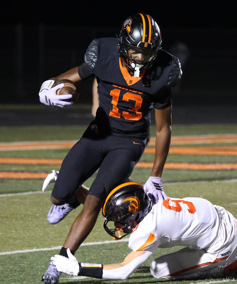 DeKalb's Davon Grant tries to get away from Lincoln-Way West's Luke Gouty during their game Friday, Oct. 3, 2025, at DeKalb High School.