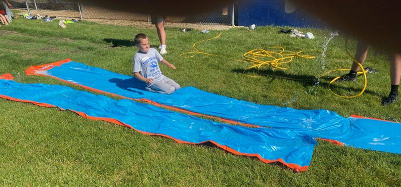 Gabriel Glover cooled down on a hot day during the final session of the Princeton Tiger Baseball Camp with sliding practice on a Slip N Slide. Coach Wick Warren had more than 70 kids in camp divided into two sessions.