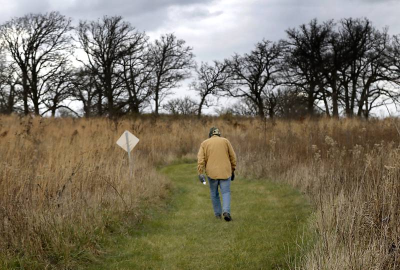 A man hikes through the McHenry County Conservation District's Glacier Park Conservation Area on Wednesday, Nov. 20, 2024, near Ringwood. According to unofficial election results, voters approved the McHenry County Conservation District’s referendum seeking to increase property taxes.