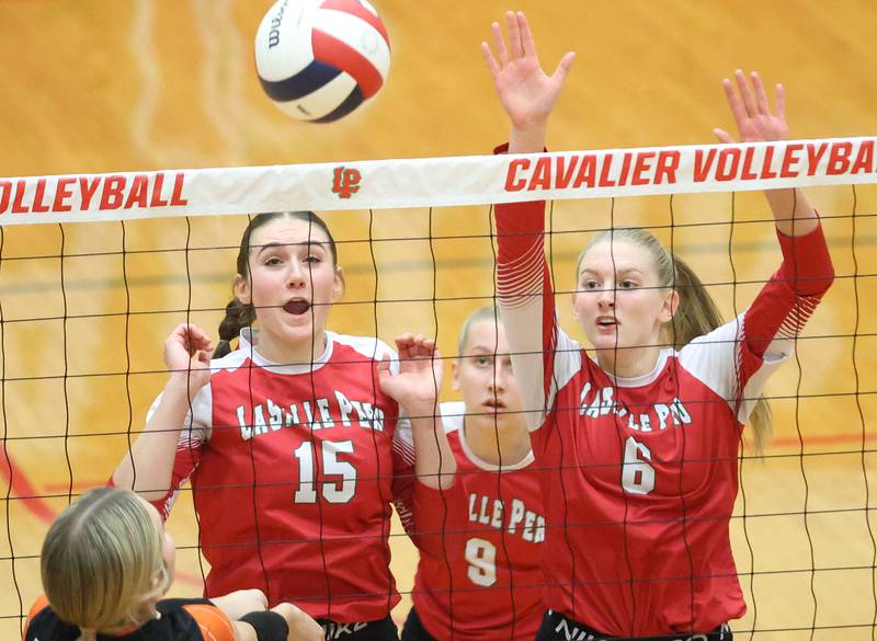The ball goes past L-P defenders Drew Depenbrock, Aubrey Urbanski and Maggie Boudreau during the Class 3A Sectional final game on Thursday, Nov. 6, 2025 in Sellett Gymnasium at L-P High School.
