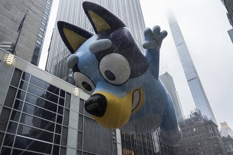 Handlers guide the Bluey balloon down Sixth Avenue during the Macy's Thanksgiving Day Parade, Thursday, Nov. 28, 2024, in New York. (AP Photo/Julia Demaree Nikhinson)