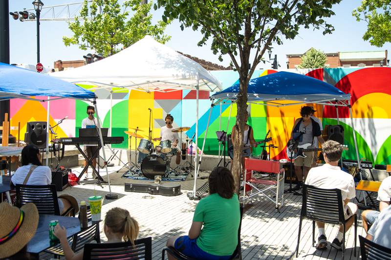 The band Double Helix performs during Make Music Wheaton and the Wheaton French Market in The Wheaton French Market Plaza on Saturday, June 21, 2025.