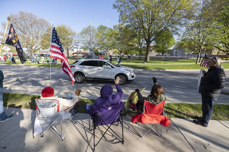 A supporter leans out of a car Friday, May 1, 2026, during a May Day protest at Central Park in Sterling. Indivisible Sauk Valley organized the gathering to continue to voice their displeasure with the Trump Administration.