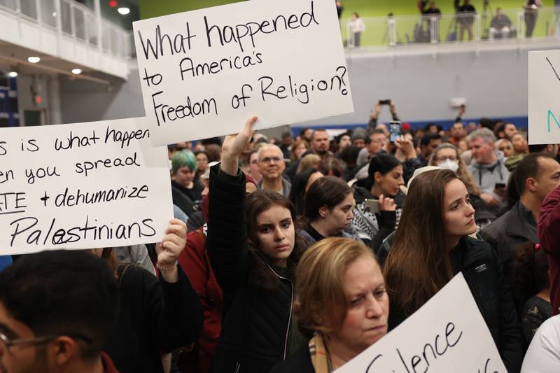 A supporter holds a sign at a vigil for Wadea Al-Fayoume at Prairie Activity & Recreation Center on Tuesday, Oct. 17, 2023 in Plainfield.