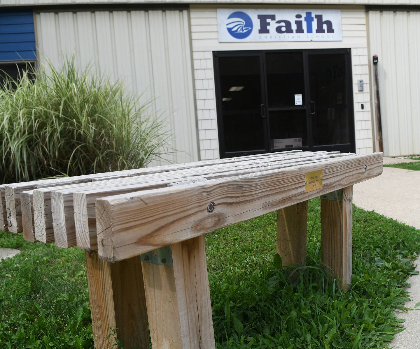 This is one of the two wooden benches Noah Hage made at entrance to Faith Christian School in Grand Detour as his 2019 Eagle Scout Project.