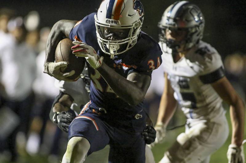 Oswego's Ammar Banire (34) runs in a late touchdown during football game between Oswego East at Oswego Friday, Oct 17, 2025 in Oswego.