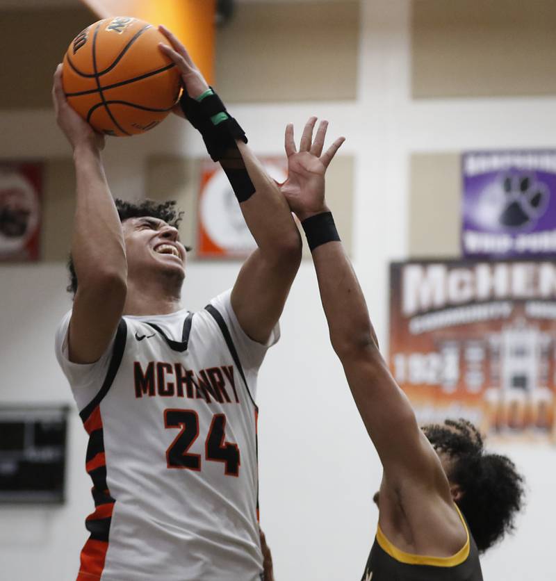 McHenry's Adam Anwar shoots the ball over Jacobs' Jordan O'connor during an IHSA Class 4A McHenry Regional basketball game on Wednesday, Feb. 26, 2025, at McHenry High School.