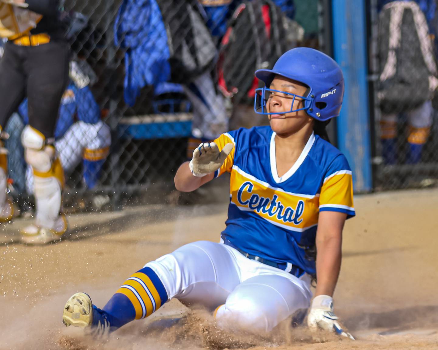 Joliet Central's Victoria Godinez (11) slides into home for a score during softball game between Joliet West at Joliet Central on Tuesday, April 15, 2025  in Joliet.