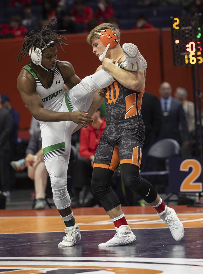 Washington’s Wyatt Medlin lifts the leg of Providence Catholic’s Jasper Harper in the 2A 165 class Saturday, Feb. 21, 2026, at the IHSA wrestling finals in Champaign.