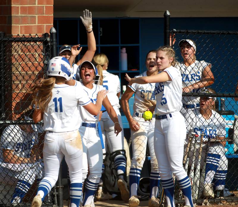 St. Charles North players celebrate a run by Ivy Gleeson during a home game against Wheaton Warrenville South on Monday, May 6, 2024.