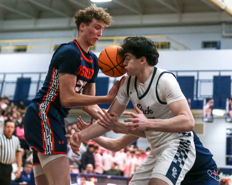 Oswego East's Marc Sanchez-Giron (25) takes a ball to the face while fighting for possession underneath the basket during their basketball game between Oswego at Oswego East, Feb 13, 2026 in Oswego.