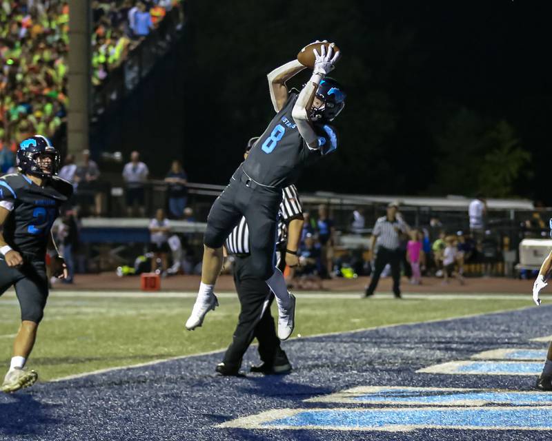 Downers Grove South's William Potter (8) leaps high for an interception during varsity football game between Willowbrook at Downers Grove South.  Sept 16, 2022