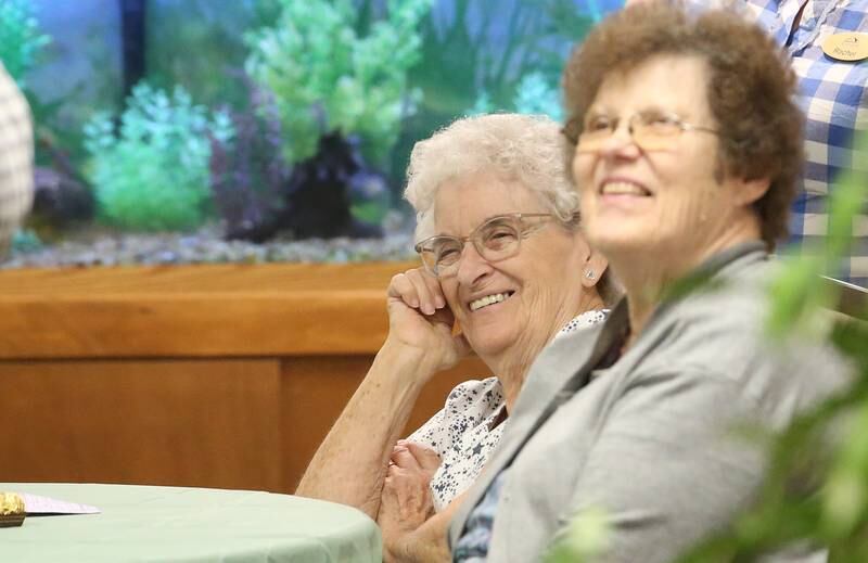 Pat Polson and Aleta Faber smile while listening to Princeton mayor Ray Mabry speak during Gorgeous Grandma Day on Wednesday, July 23, 2025 at the Greenfield Retirement Home in Princeton. Mayor Mabry spoke to the residents, handed out rubber ducks and told stories about Princeton. a day to honor and appreciate grandmothers, recognizing their beauty, wisdom, and the important role they play in families and communities. The day encourages people to show their love and gratitude to grandmothers and to celebrate women of all ages who embrace the spirit of a "gorgeous grandma".