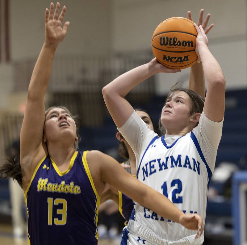Newman’s Lucy Oetting puts up a shot over Mendota’s Ella Martin Thursday, Jan. 23, 2025.