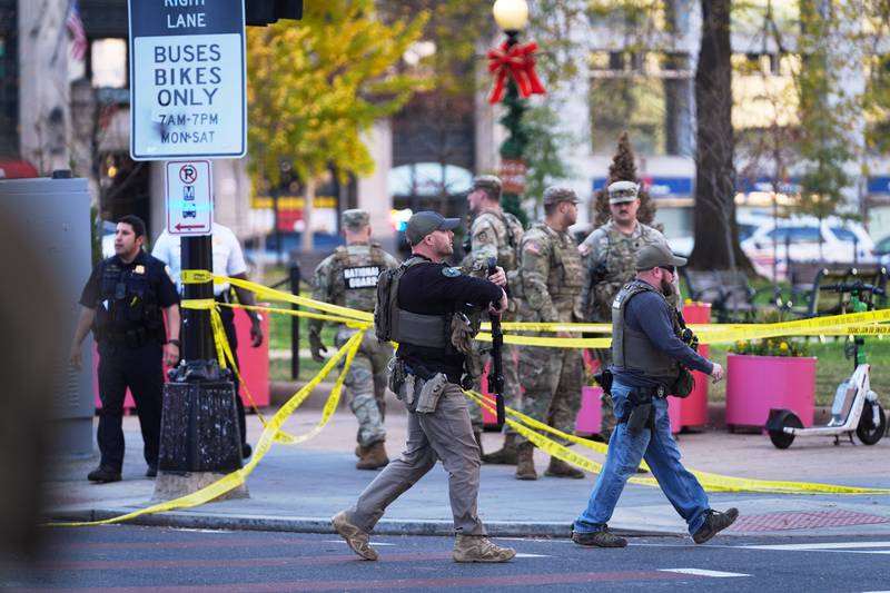 U.S. Marshalls and National Guard troops are seen after reports of two National Guard soldiers shot near the White House in Washington, Wednesday, Nov. 26, 2025. (AP Photo/Evan Vucci)