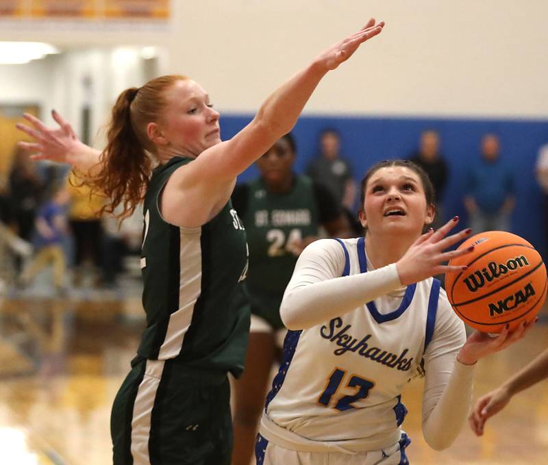 Johnsburg's Addie Graff (right) drives to the basket agains tSt. Edward's Layne Dawson during the IHSA Class 2A Johnsburg Sectional girls basketball championship game on Thursday, February, 26, 2026, at Johnsburg High School.