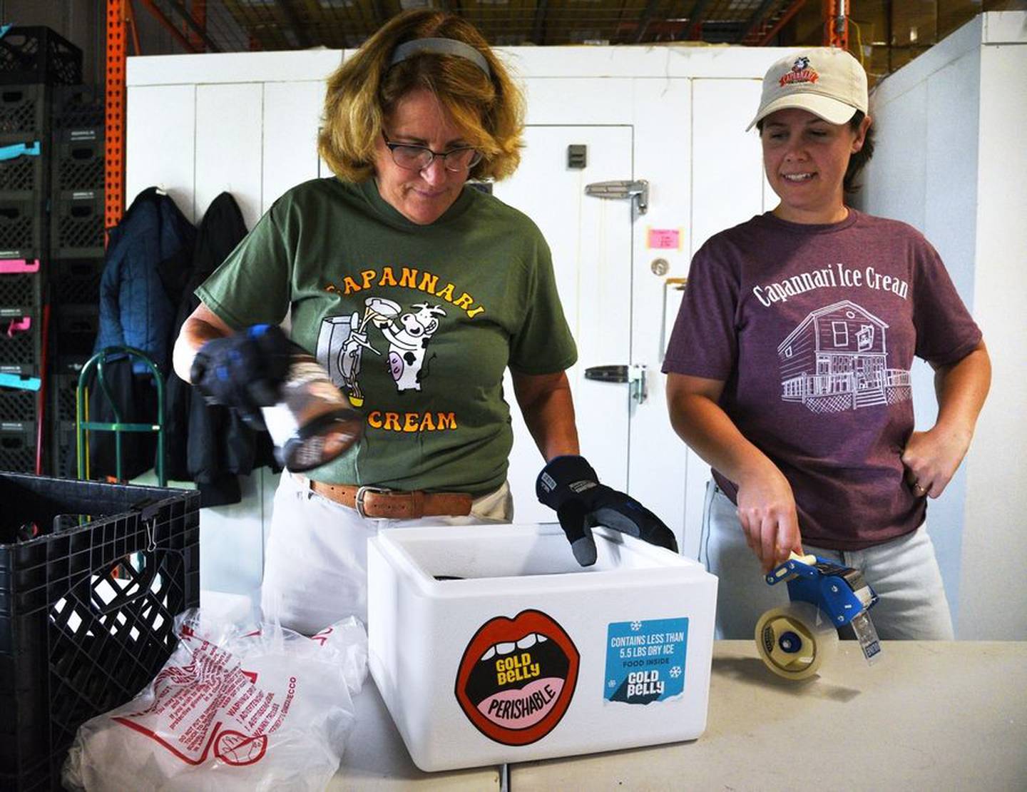 Laura Urbe, left, a 14-year employee at Capannari Ice Cream, and general manager Meg Dix, use insulated containers and dry ice to pack Goldbelly orders.