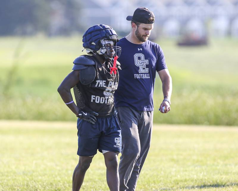 Jamari McKay has a conversation with a coach during punt return drills at Oswego East High School football practice, Monday, Aug 13, 2025 in Oswego.