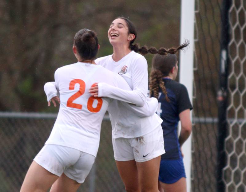 Crystal Lake Central’s Jillian Mueller (28) is greeted by Addison Schaffer after a Mueller goal in varsity soccer at Burlington Thursday night.