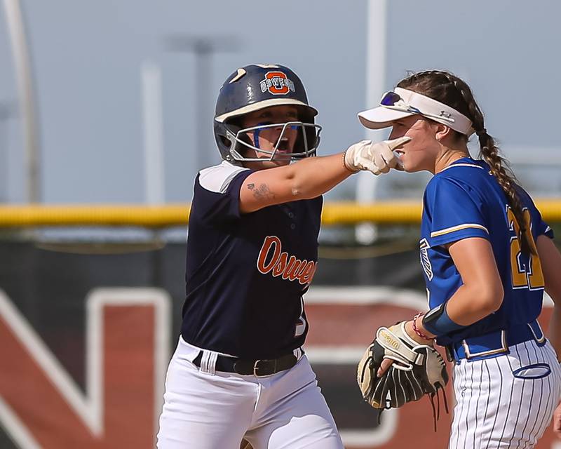 Oswego's Marissa Moffett (5) points to the dugout after sliding safely into second during Class 4A Plainfield North Sectional final softball game between Wheaton North at Oswego. May 31th, 2024.