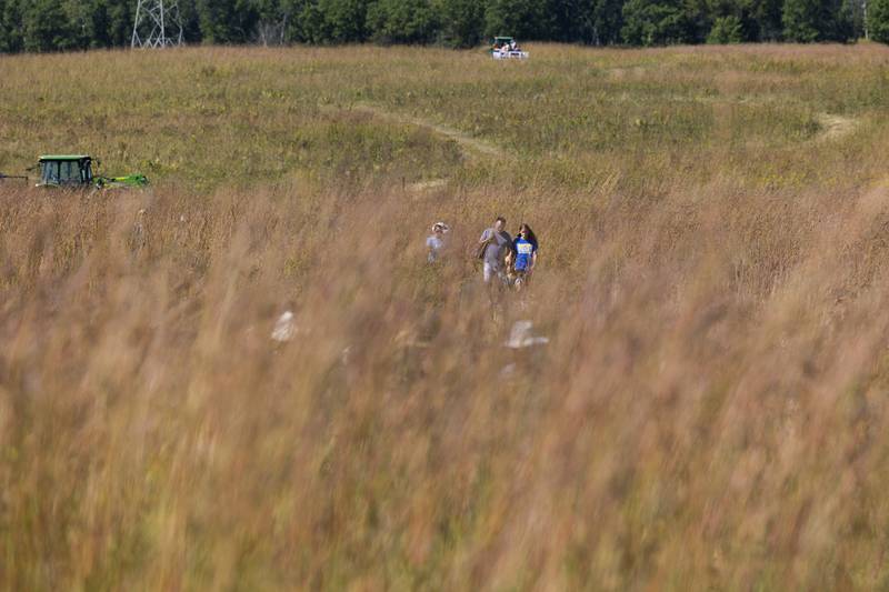 Visitors follow trails through the seas of grass Saturday, Sept. 21, 2024, at the Nachusa Grasslands.