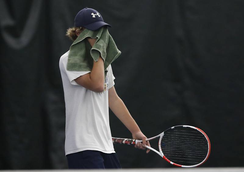 Sterling’s Brecken Peterson wipes sweat from his face during his IHSA 1A boys single tennis match against Lake’s Gavin Murrie Thursday, May 26, 2022, at Heritage Tennis Club in Arlington Heights.
